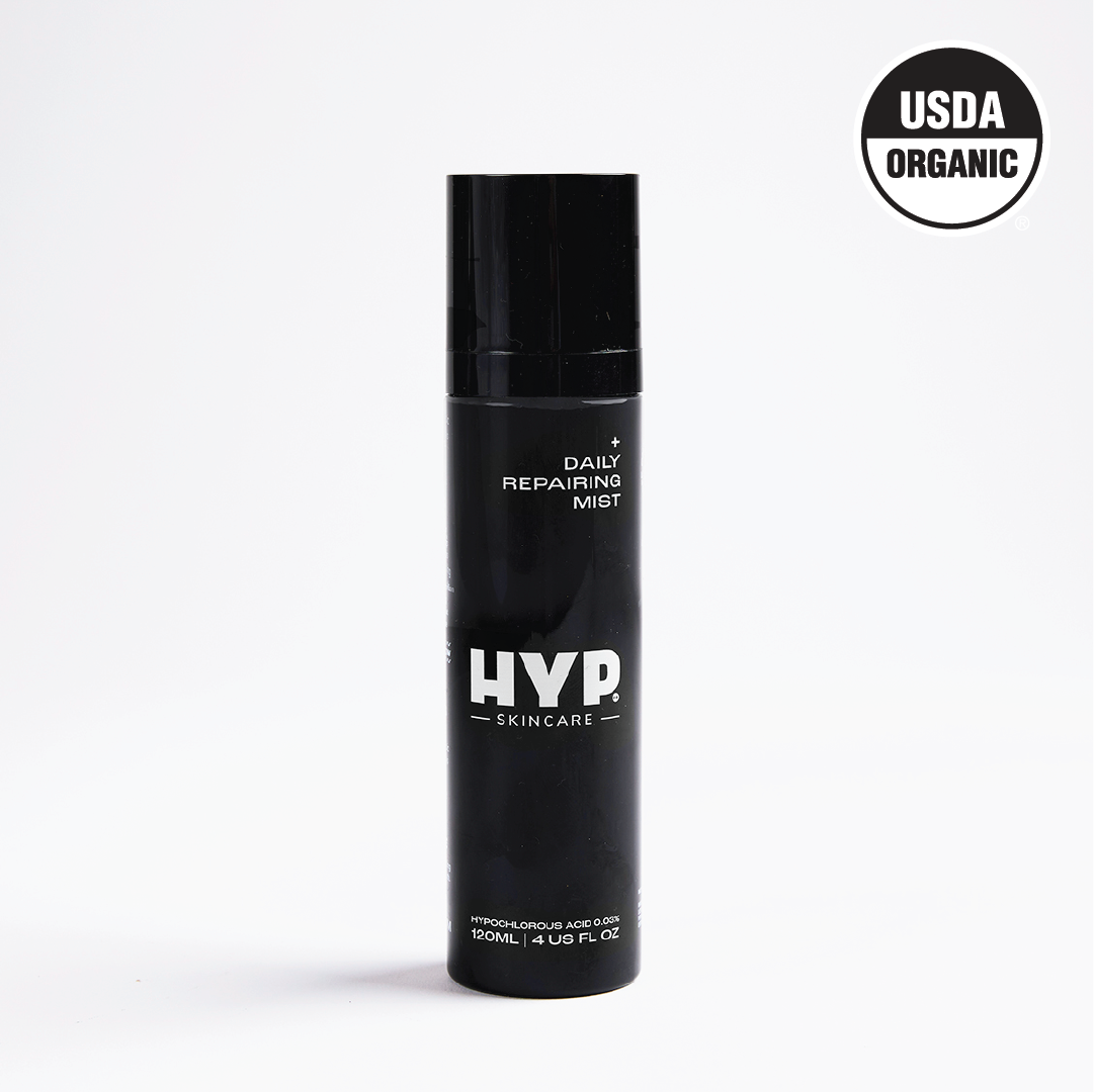 A standalone image of a black bottle of 'HYP Daily Repairing Mist' set against a plain white background. The product is labeled with the brand name 'HYP' in large white letters and the words 'Daily Repairing Mist' above it. The 'USDA ORGANIC' seal is visible in the upper right corner of the bottle, certifying its organic status.