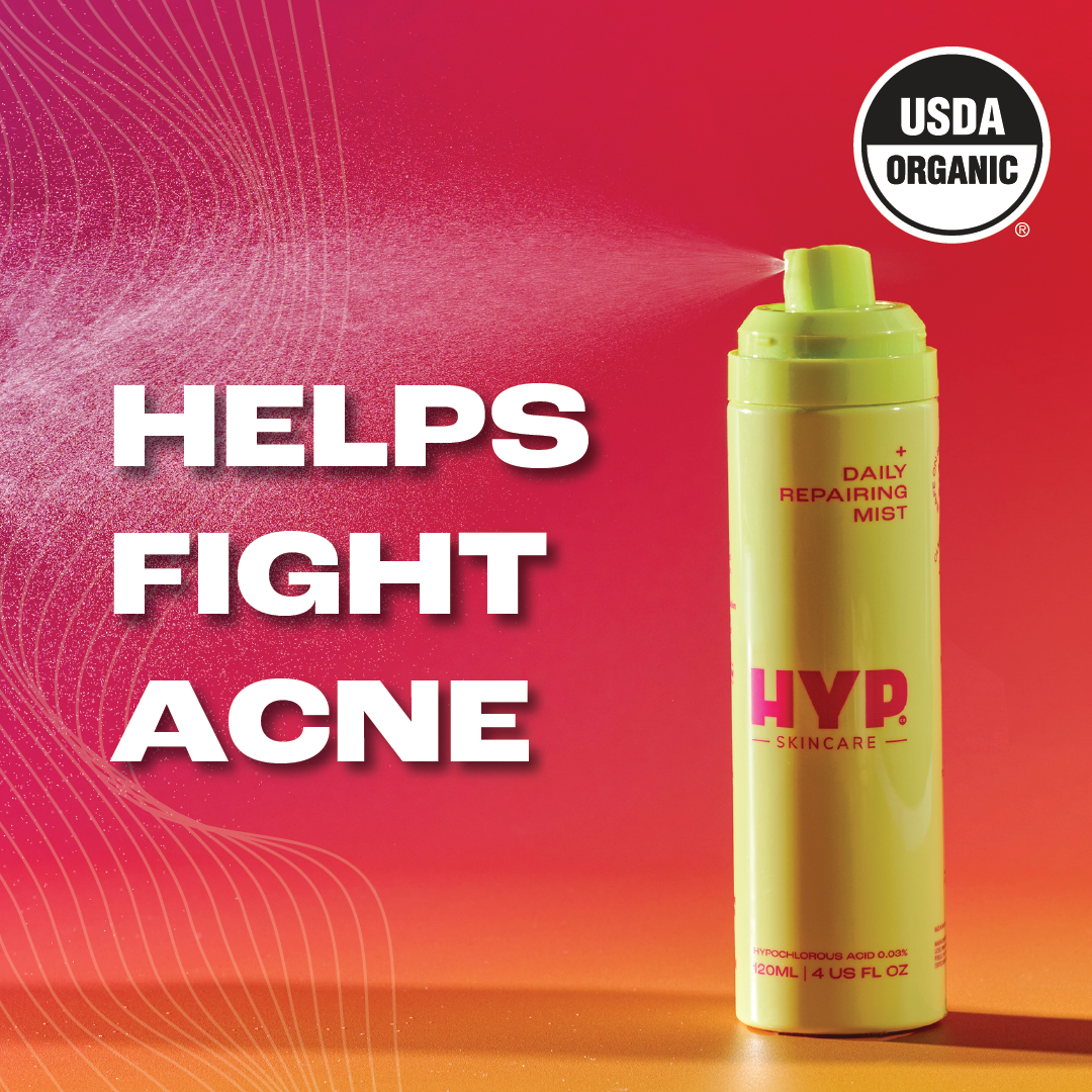 A graphic featuring a bright yellow skincare spray bottle labeled 'HYP Daily Repairing Mist' against a vibrant red to orange gradient background. Bold white text states 'HELPS FIGHT ACNE' along with a 'USDA ORGANIC' seal in the upper left corner, suggesting the product is certified organic and intended for acne treatment.
