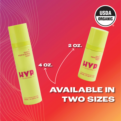 Image featuring two bottles of 'HYP Daily Repairing Mist' against a gradient background transitioning from red to orange. The larger bottle on the left is annotated with '4 OZ.' and the smaller bottle on the right with '2 OZ.' An arrow points to each bottle from the bold white text at the bottom that reads 'AVAILABLE IN TWO SIZES.' The 'USDA ORGANIC' seal is displayed in the upper right corner of the image, signifying the product's organic certification.