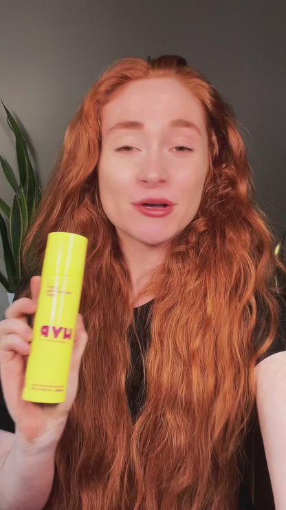 Video featuring an influencer demonstrating the effectiveness of the HYP Daily Repairing Mist. Filmed in a living room setting, the influencer applies the product while discussing its benefits. The brand logo and key phrases such as ‘take an acid trip for your skin” and “amazing to fight breakouts.” The content is upbeat and informative, aimed at those interested in skincare.